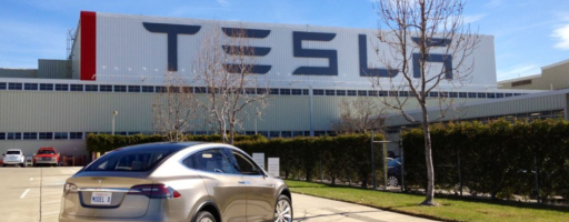 brand tesla in the front of the factory